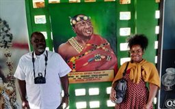 visitors posing with portrait of otumfuo opoku ware ii